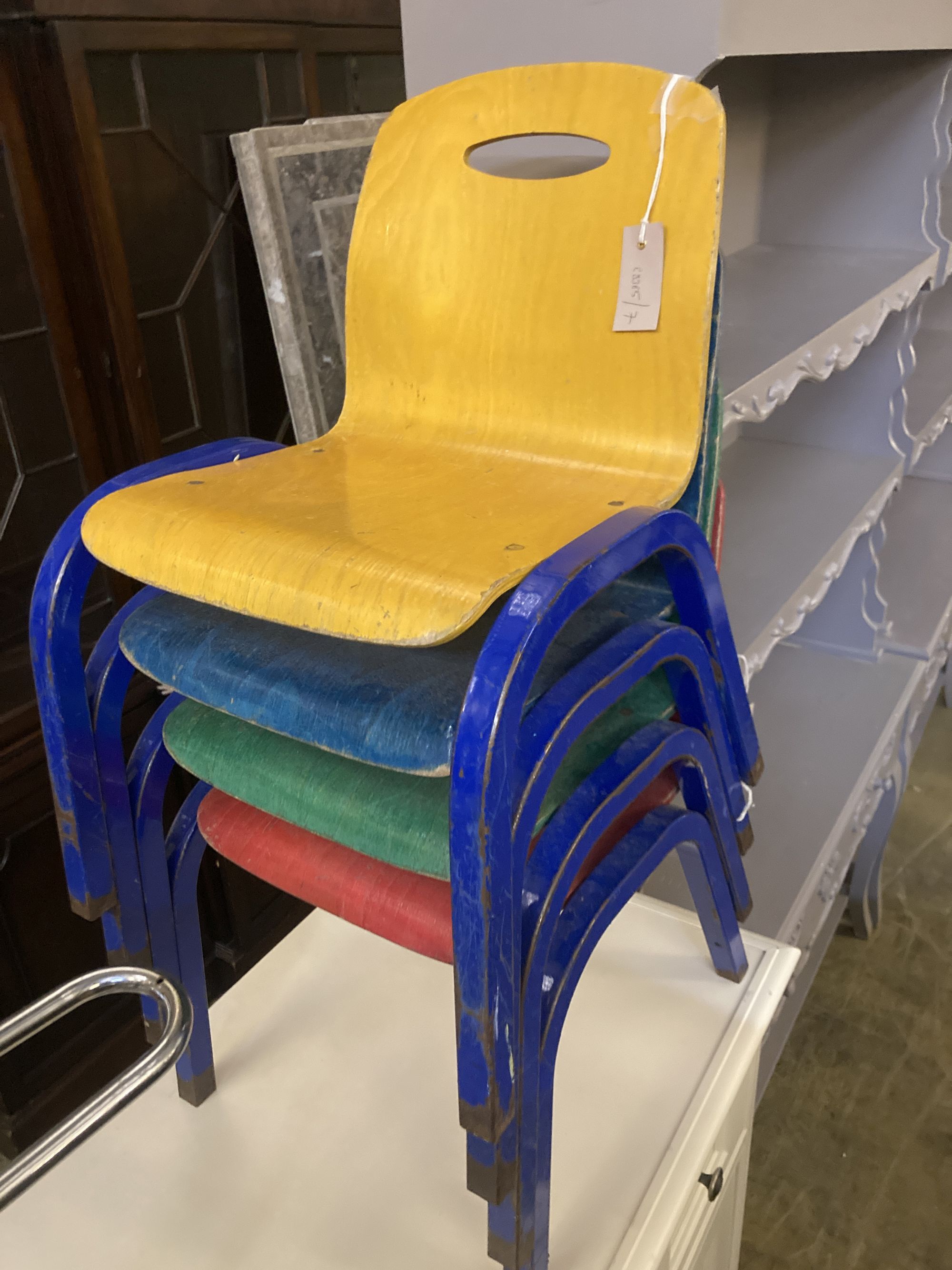 A set of four metal and ply childs stacking chairs